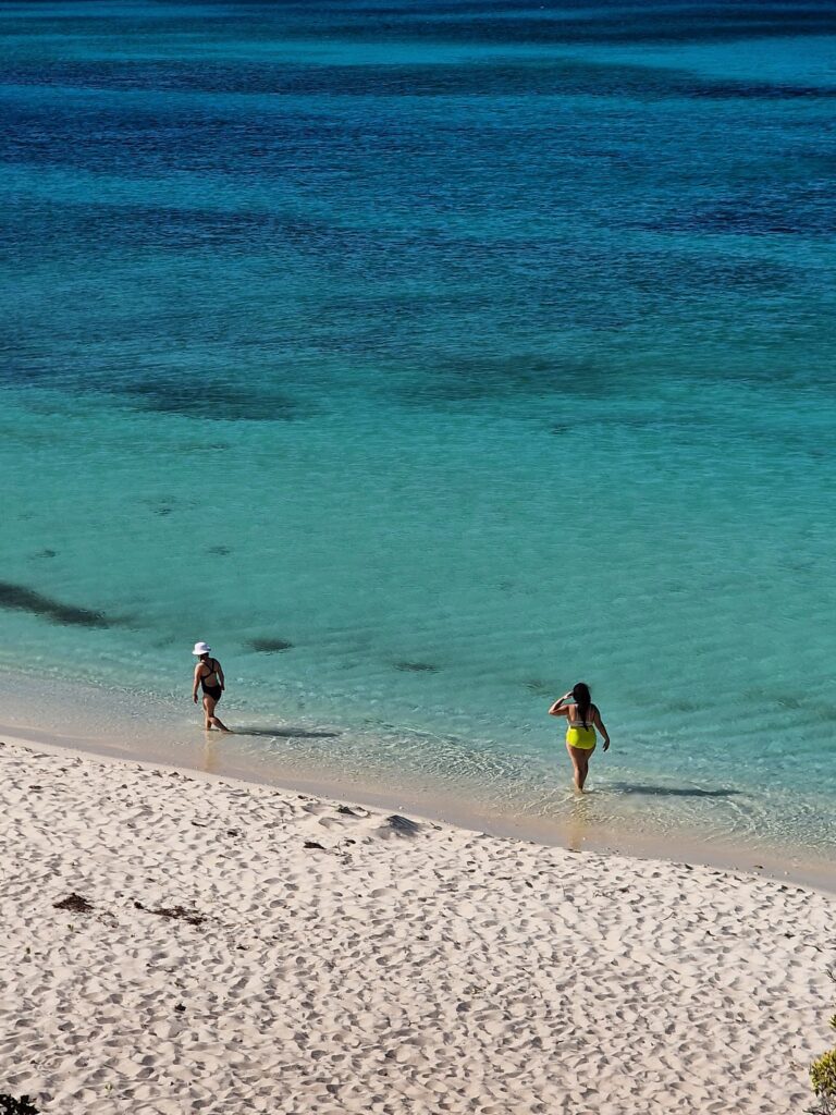 people swimming empty white beach bahia de aguillas southwest