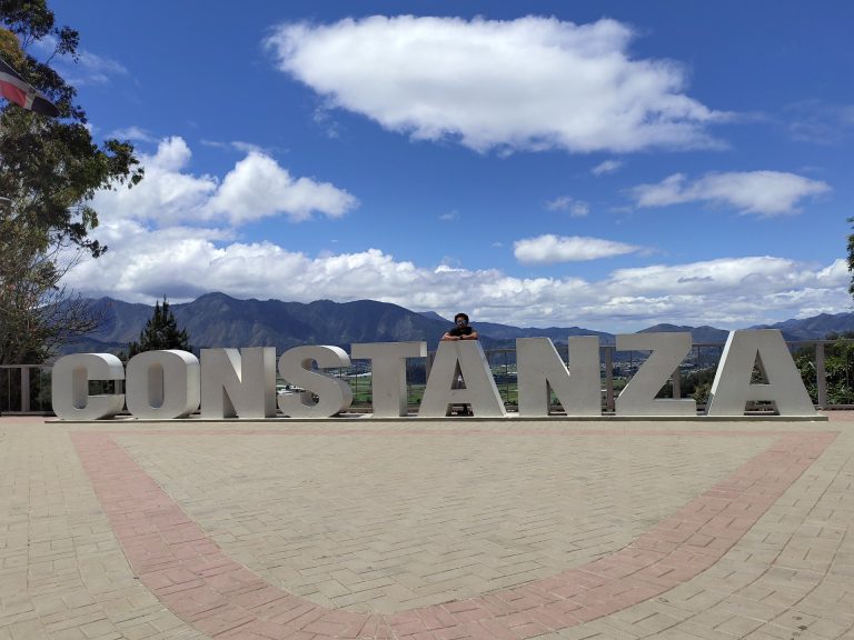 constanza town sign letters mountain valley backdrop