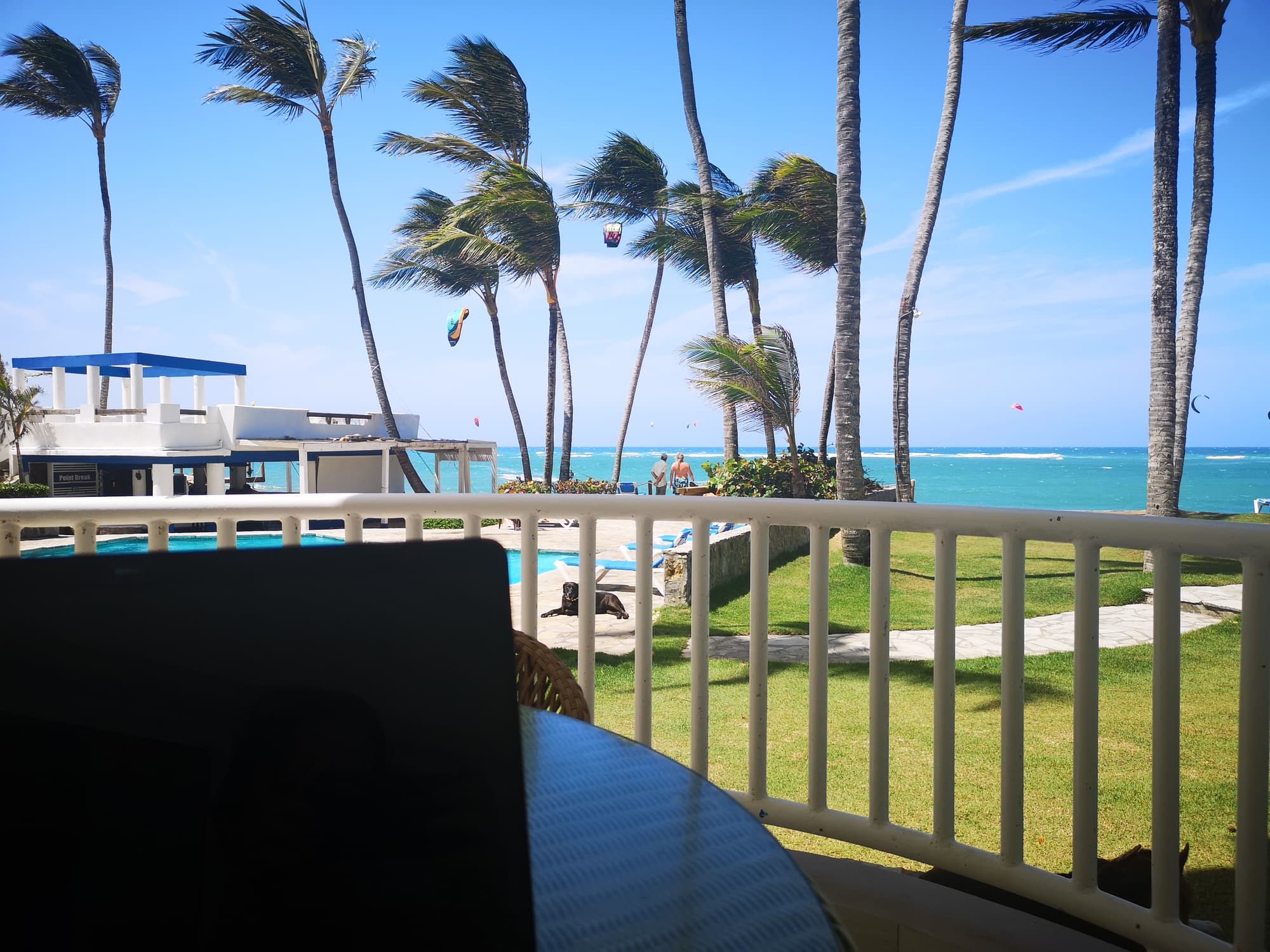 Laptop open on a balcony overlooking Kite Beach, Cabarete, Dominican Republic