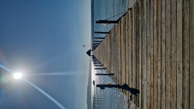 long wooden pier sun glare punta rucia lodge