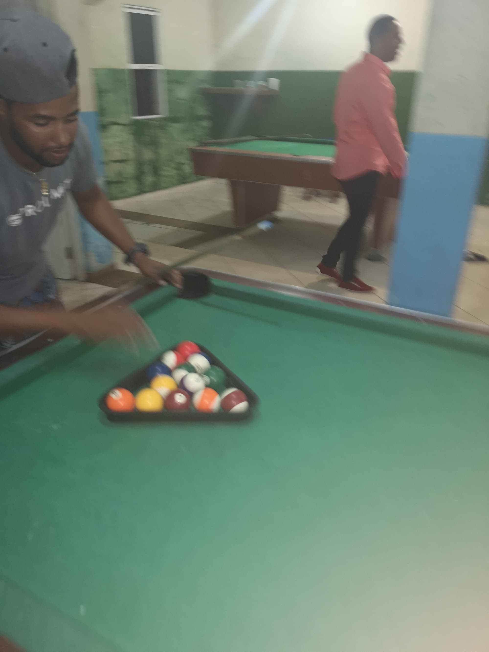 Men playing pool in a billiard hall in La Cienega, Cabarete, Dominican Republic