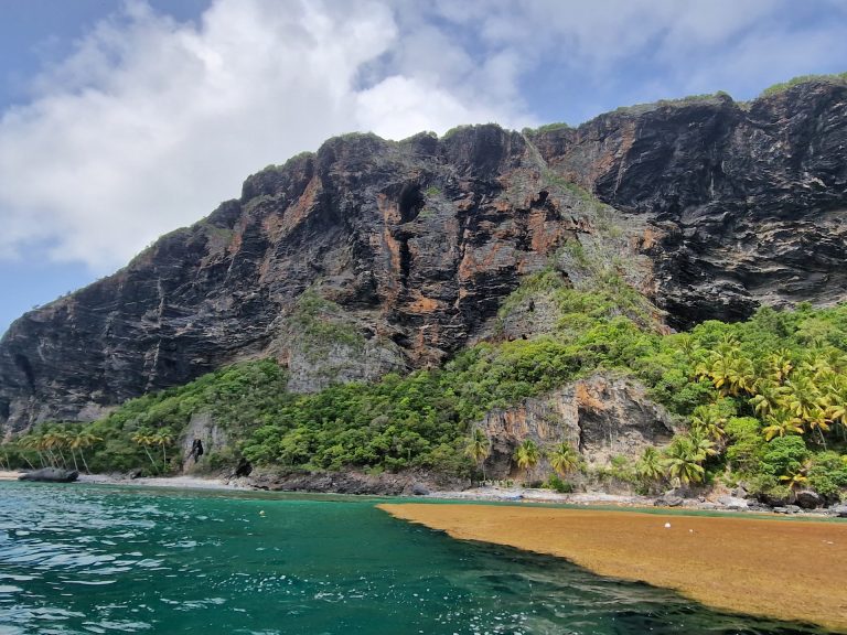 playa fronton dramatic black rock cliff from sea samana