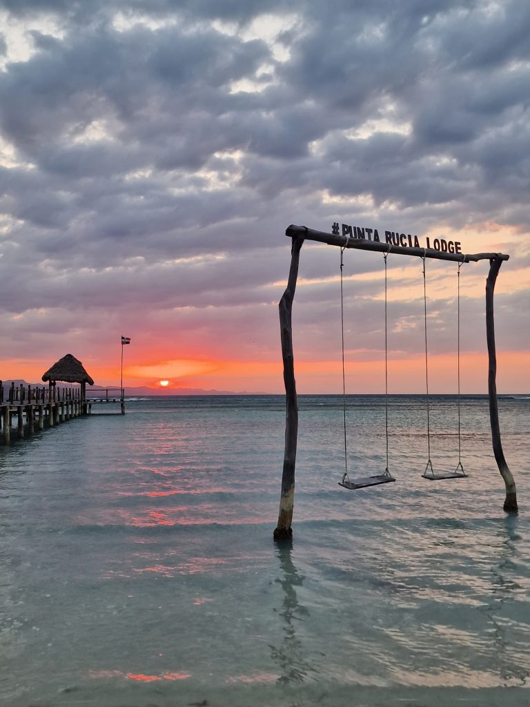 punta rucia lodge sign arch red orange sunset