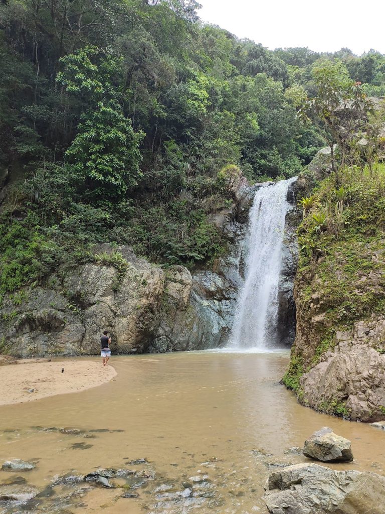 salto jimenoa waterfall gorge rocky river person jarabacoa