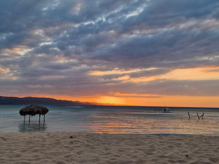 sunset thatched palapa shallow water fishing boat punta rucia