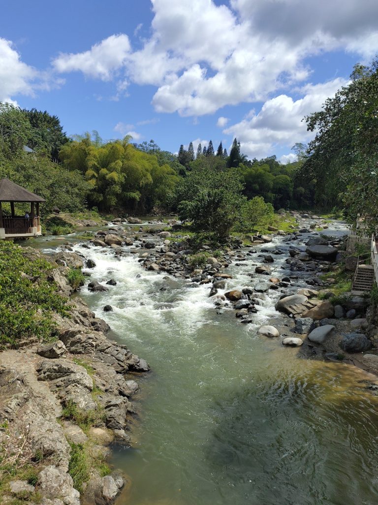 yaque del norte rapids boulders bridge lush vegetation jarabacoa