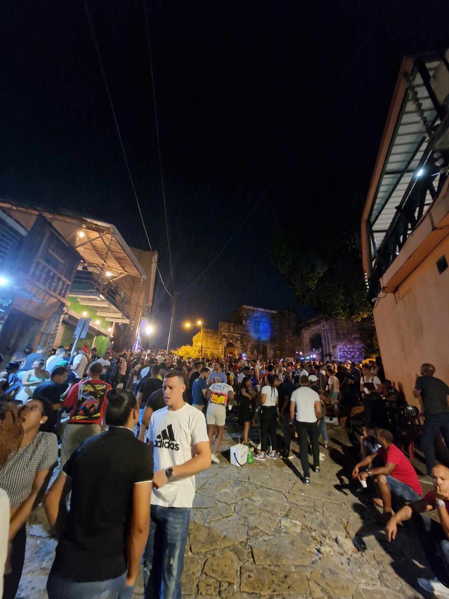 Cobblestone street nightlife crowd in Zona Colonial, Santo Domingo